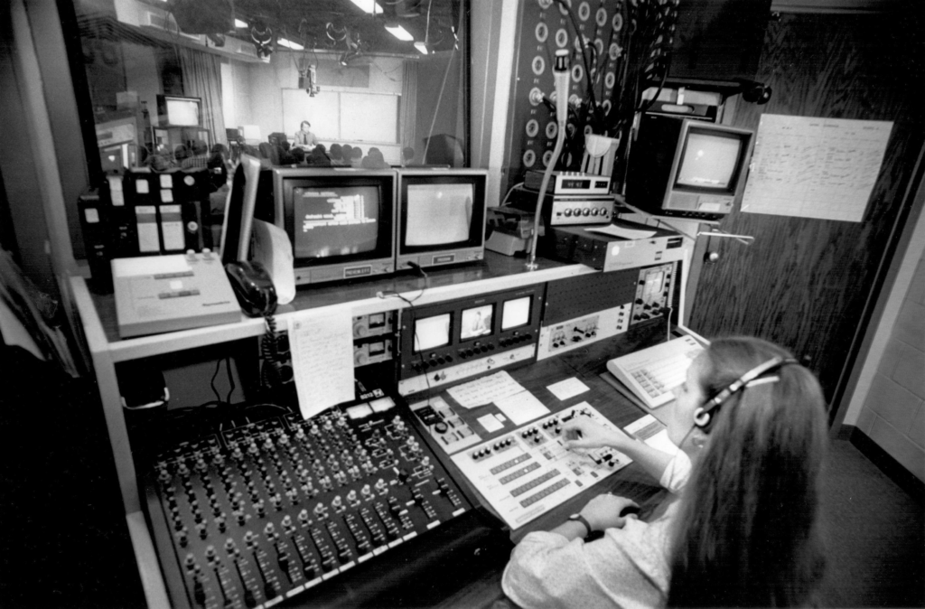 A female technician in the production booth of the Video Instructional Program