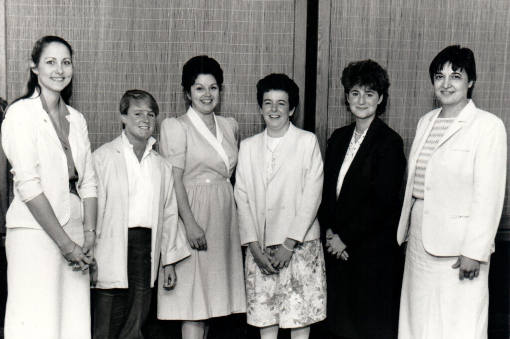 1985 Women in Engineering Program awardees stand in a line to pose for a photo